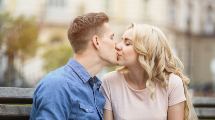 Fototapeta premium Sweet kiss of beautiful young couple in love, happy people enjoying romance