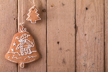 Christmas gingerbread hanging over wooden background