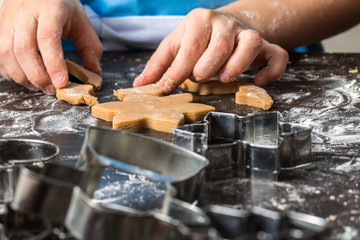Fototapeta na wymiar child cutting out cookies from dough at home kitchen.