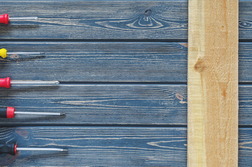 many screwdrivers on blue wooden background