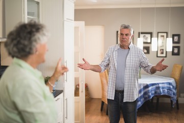 Angry senior man looking at female partner