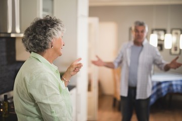 Fototapeta na wymiar Angry senior couple talking at home