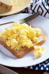 Breakfast in bed for two, scrambled eggs, cheesecake, morning, vertical, selective focus
