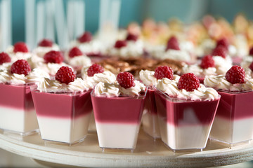 Delicious fruit jellies at candy buffet of a restaurant whipped cream raspberry berries decoration...