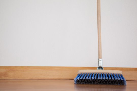 Sweeping Broom With Wooden Handle On Floor