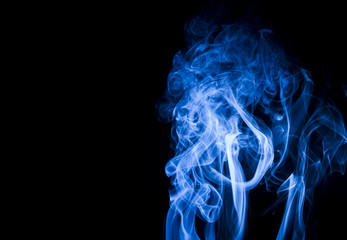 Blue smoke on black background