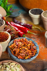 Variety of different asian and middle east spices, colorful assortment, on old wooden table