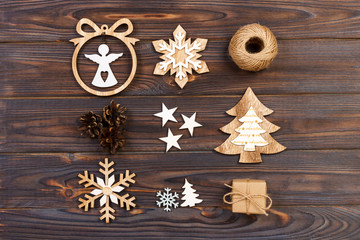 Christmas composition. Christmas snowflakes, Christmas tree and angel in a frame on a wooden background. New Year wooden decorations