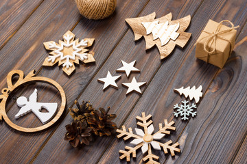 Christmas composition. Christmas snowflakes, Christmas tree and angel in a frame on a wooden background. New Year wooden decorations