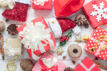 Table top view image of decorations Merry Christmas & Happy New Year background concept.Many beautiful gift boxes and ornaments decor seasonal on modern rustic white wooden at home office desk studio.