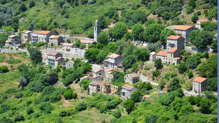 Corsican rural village in mountains with a destroyed house foreground