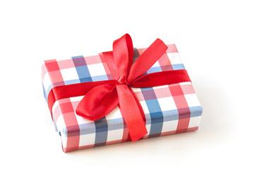 Gift box wrapped in checked design paper, tied with red ribbons. Festive packaging mock up