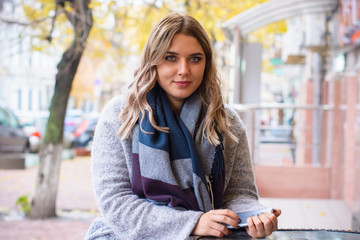 Cute simple woman with blonde hair of size plus size walks through the shopping looks in showcases chooses things like shopping and beautiful stylish accessories reflects on her appearance