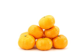 Pile of many orange fruits on white background, side view