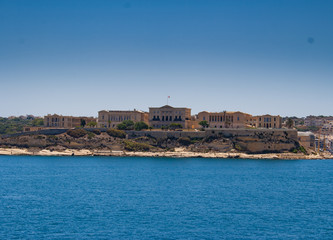 Fototapeta na wymiar Military Buildings Across the Harbour in Malta