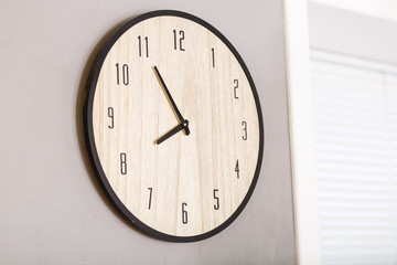Five minutes to eight o clock on the dial round wall clock