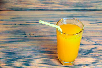 oranges and orange juice on a wooden background