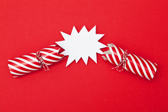 Popped Christmas crackers on a red background