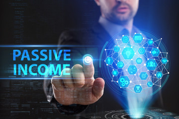 The concept of business, technology, the Internet and the network. A young entrepreneur working on a virtual screen of the future and sees the inscription: Passive income