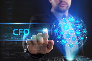 The concept of business, technology, the Internet and the network. A young entrepreneur working on a virtual screen of the future and sees the inscription: CFO