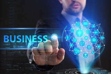 The concept of business, technology, the Internet and the network. A young entrepreneur working on a virtual screen of the future and sees the inscription: Business
