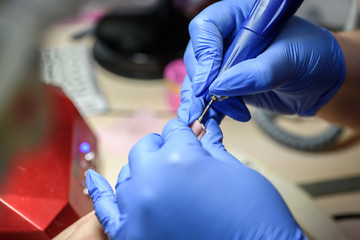 Manicure. Master does manicure on nails paint hand