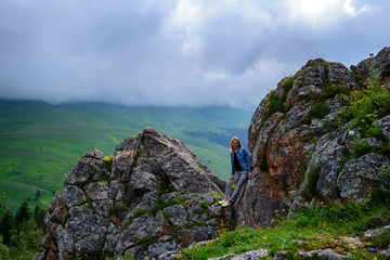 Female hiker standing on edge of rock