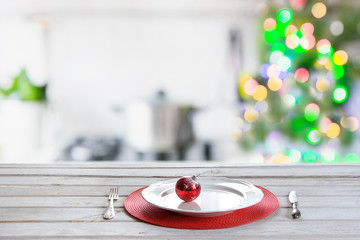 Christmas table background with christmas tree in kitchen out of focus. Background for display your products.