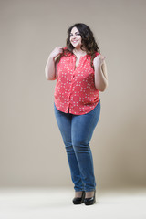 Happy plus size fashion model, sexy fat woman on beige background