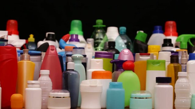 Sliding camera in front of lots of plastic bottles - usually found in every household