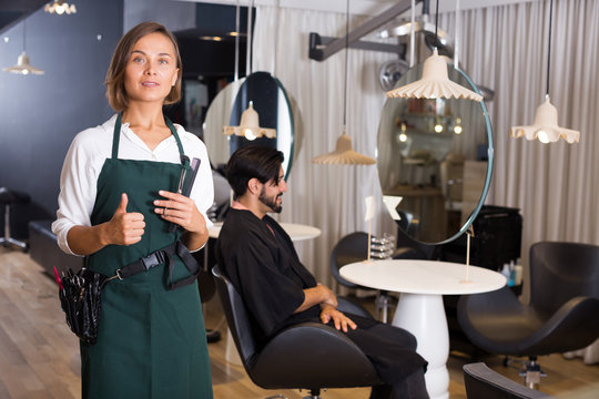 positive woman hairdresser thumbs up
