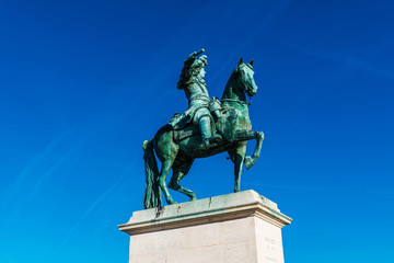 Obraz premium King Louis XIV statue at Palace of Versailles