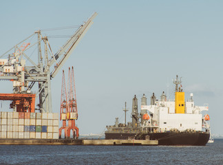 Fototapeta na wymiar Industrial sea port with containers and cranes and ship.