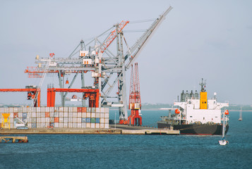 Fototapeta premium Industrial sea port with containers and cranes and ship.