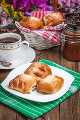 Buns with berries on a wooden table.