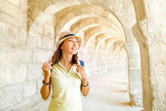 Happy woman tourist travels in famous ancient town Aspendos in Turkey, historical and archeology concept