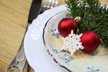 Festive table with Christmas decorations. Plates with festive decor. Close-up.
