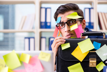Businessman with reminder notes in multitasking concept