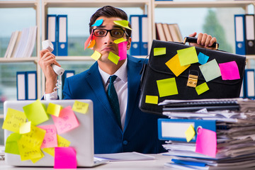 Businessman with reminder notes in multitasking concept