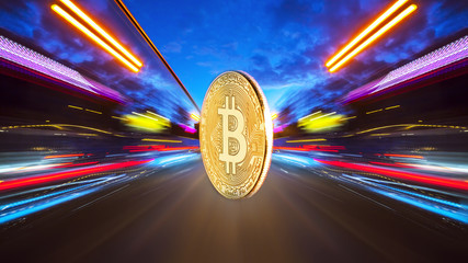 The physical coin is a gold bitcoin on a night road with speed traffic light trails abstract background. Concept Bitcion is speedy money.