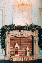 Christmas decoration in grunge room interior with fireplace, horse rocking kids chair, classic new year tree with presents