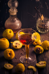 Tincture cup fruit quince wooden table