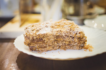 A puff cake on a table in a cafe. Close-up, soft focus. Toning in the style of instagram.