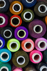 Sewing threads in assortment close-up on the shelf.