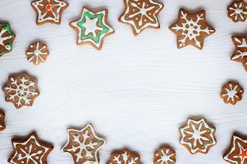 festive frame made of baked goods/ snowflakes and asterisks of ginger biscuits with a glaze on the...