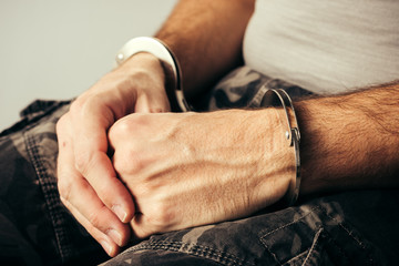 Handcuffed soldier in military army clothes