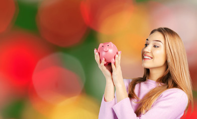Woman Holding a Piggy Bank