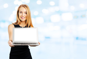 Young cheerful smiling businesswoman holds laptop