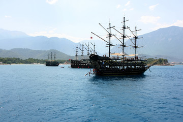 Pirate ship in the sea against the background of mountains