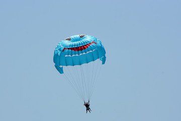 A water parachute floating in the sky with a smile.